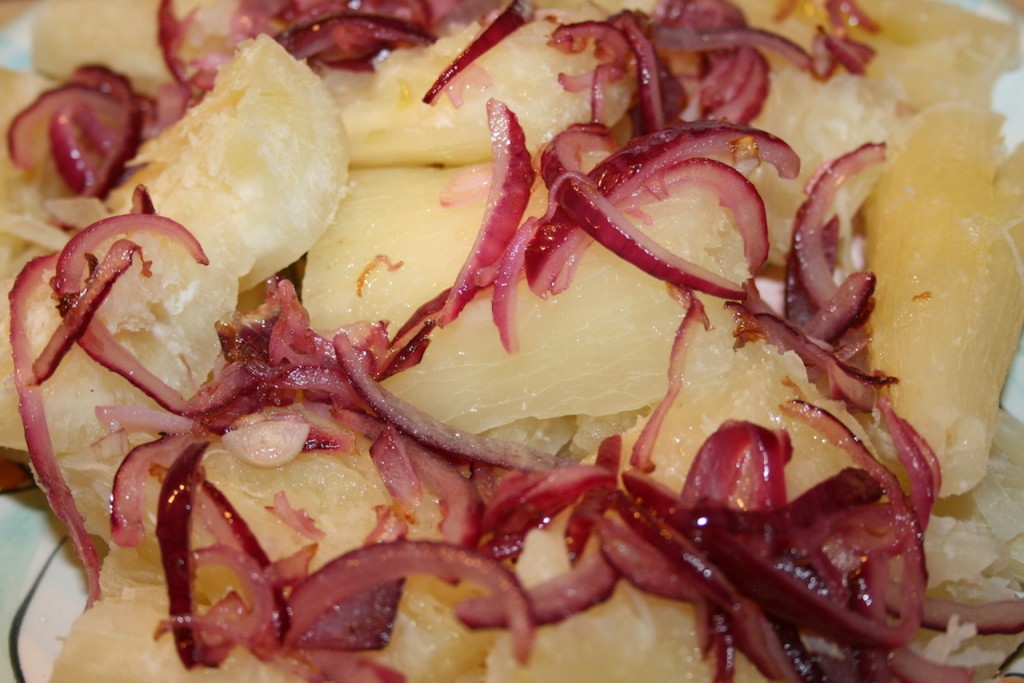 Boiled yuca with onions yuca encebollada. yucca with red picled onions. biteslife.com